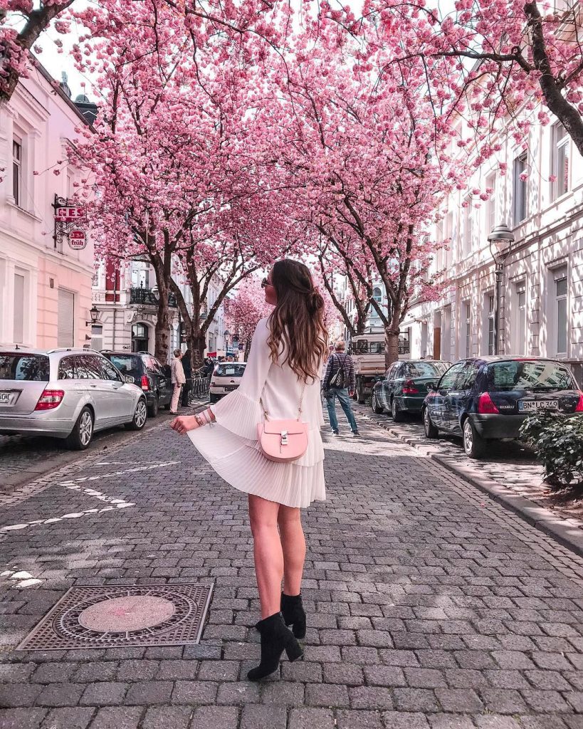  White Pleated Mini Dress + Pink Crossbody Bag + Black Ankle Boots