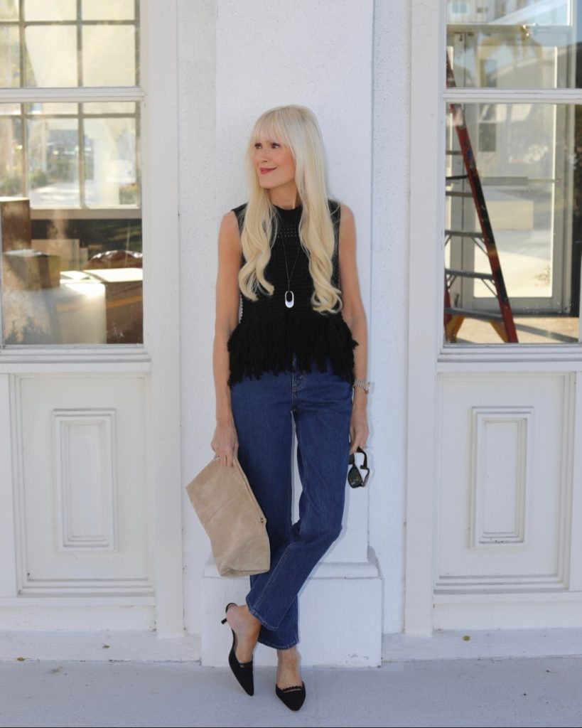 Black Sleeveless Knit Top + Straight-Leg Jeans + Suede Clutch