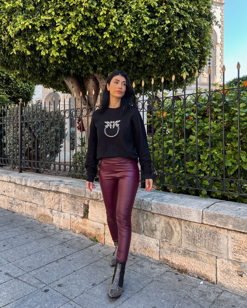 Black Graphic Sweatshirt + Burgundy Faux-Leather Leggings + Studded Boots