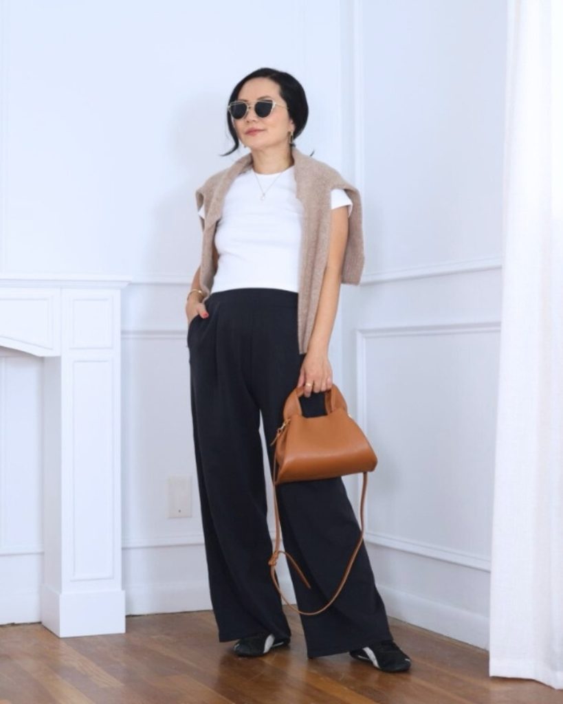  White T-Shirt + Tan Sweater (Shoulder-Draped) + Black Wide-Leg Trousers