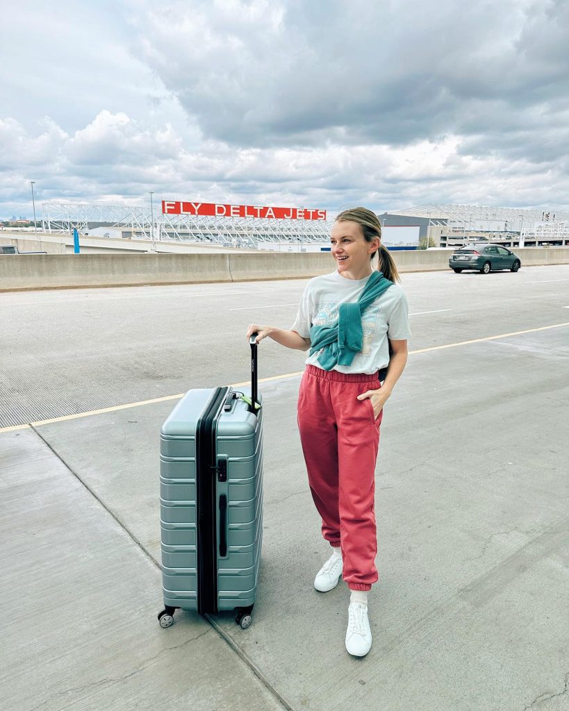 Graphic T-Shirt + Green Sweatshirt (Shoulder-Draped) + Pink Joggers