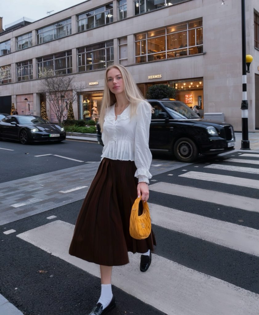 White Ruffled Blouse + Brown Pleated Midi Skirt + White Socks & Loafers
