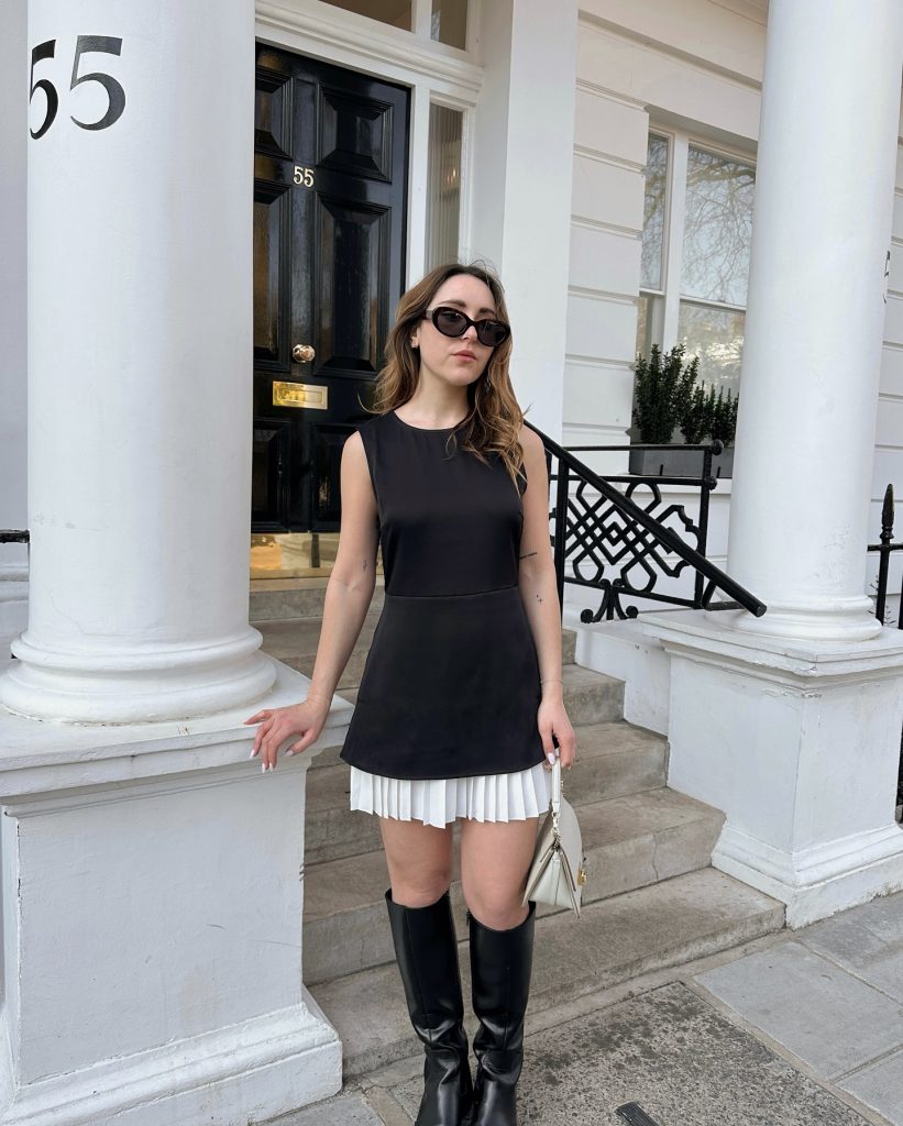 Black Sleeveless Tunic + Pleated Mini Skirt + Knee-high Boots