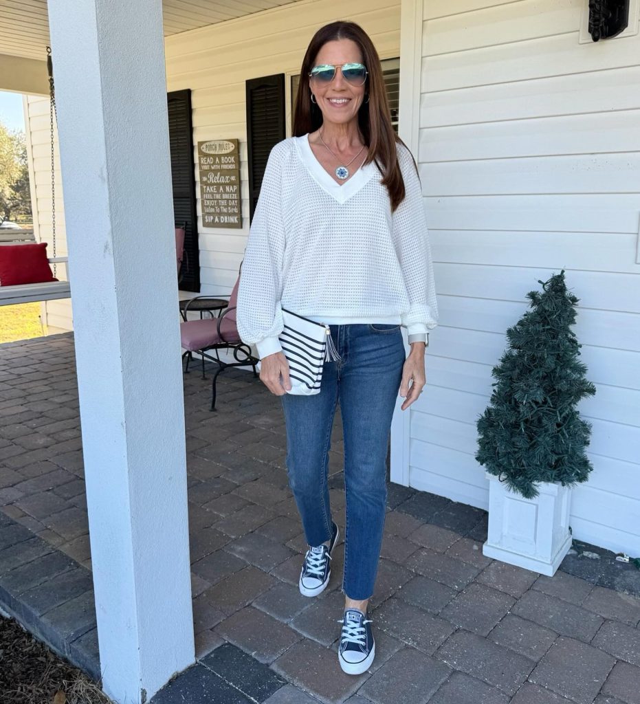 White V-Neck Knit + Striped Clutch + Skinny Jeans