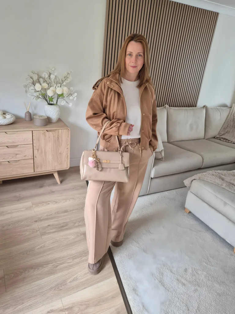 Tan Bomber Jacket + Neutral Wide-Leg Pants + Beige Handbag