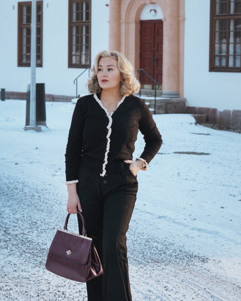 Black Scalloped Cardigan + Black Wide-Leg Trousers + Burgundy Handbag