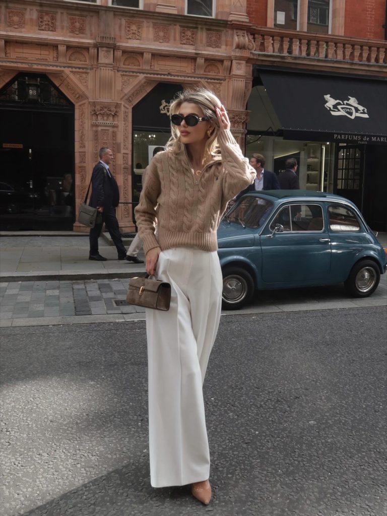 Tan Cable-Knit Sweater + White Wide-Leg Trousers + Oval Sunglasses