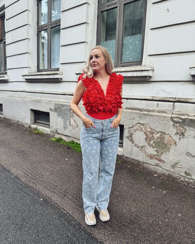 Red Sculptural Ruffle Bodysuit + Light Wash Floral Jeans