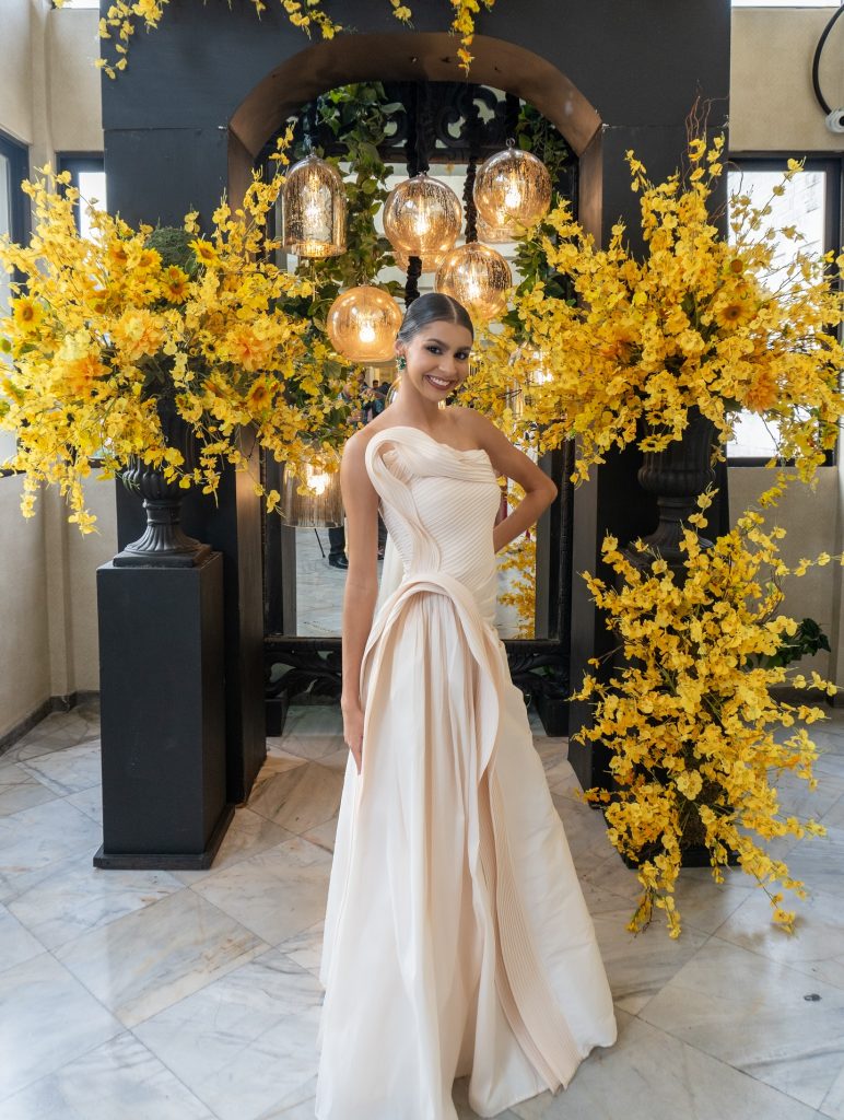 Cream Sculptural Gown + Emerald Earrings + Floral Backdrop