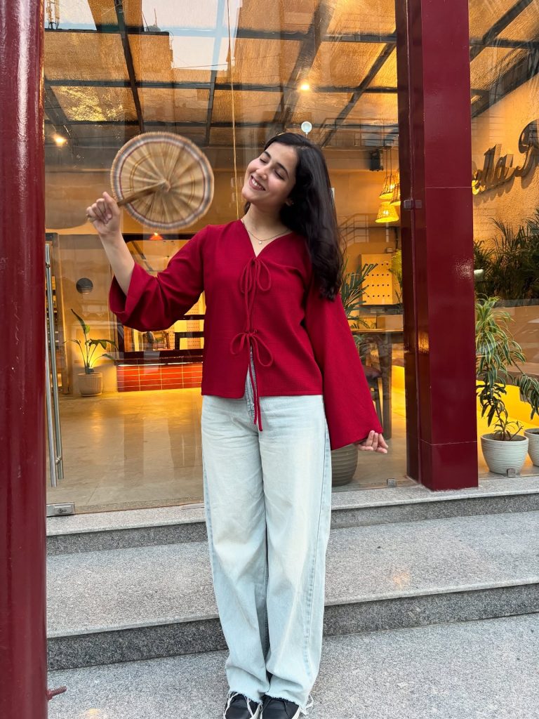 Red Tie-Front Bell-Sleeve Top + Baggy Light-Wash Jeans + Black Sneakers