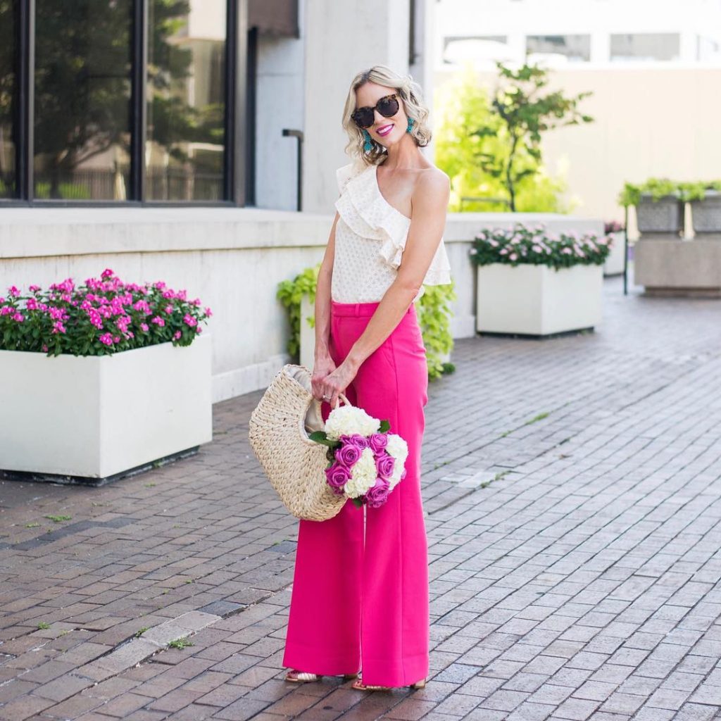 White Ruffled One-Shoulder Top + Hot Pink Wide-Leg Trousers + Straw Tote