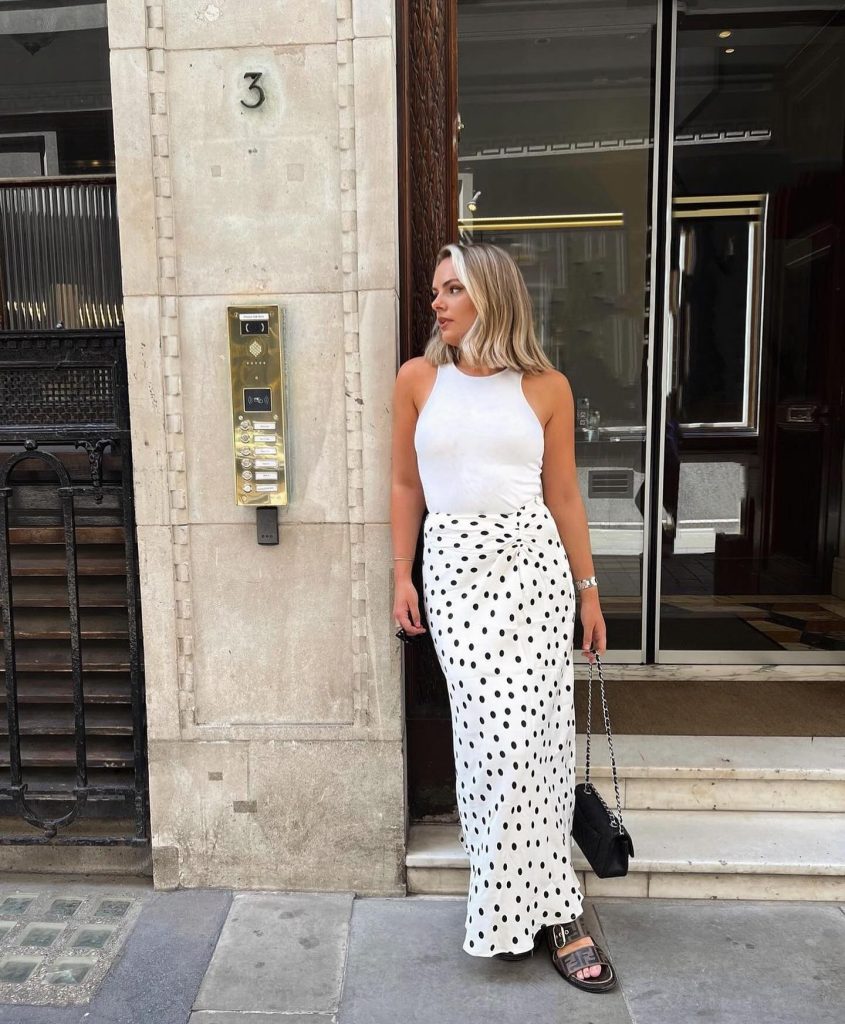 White High-Neck Tank + Polka Dot Maxi Skirt + Black Shoulder Bag