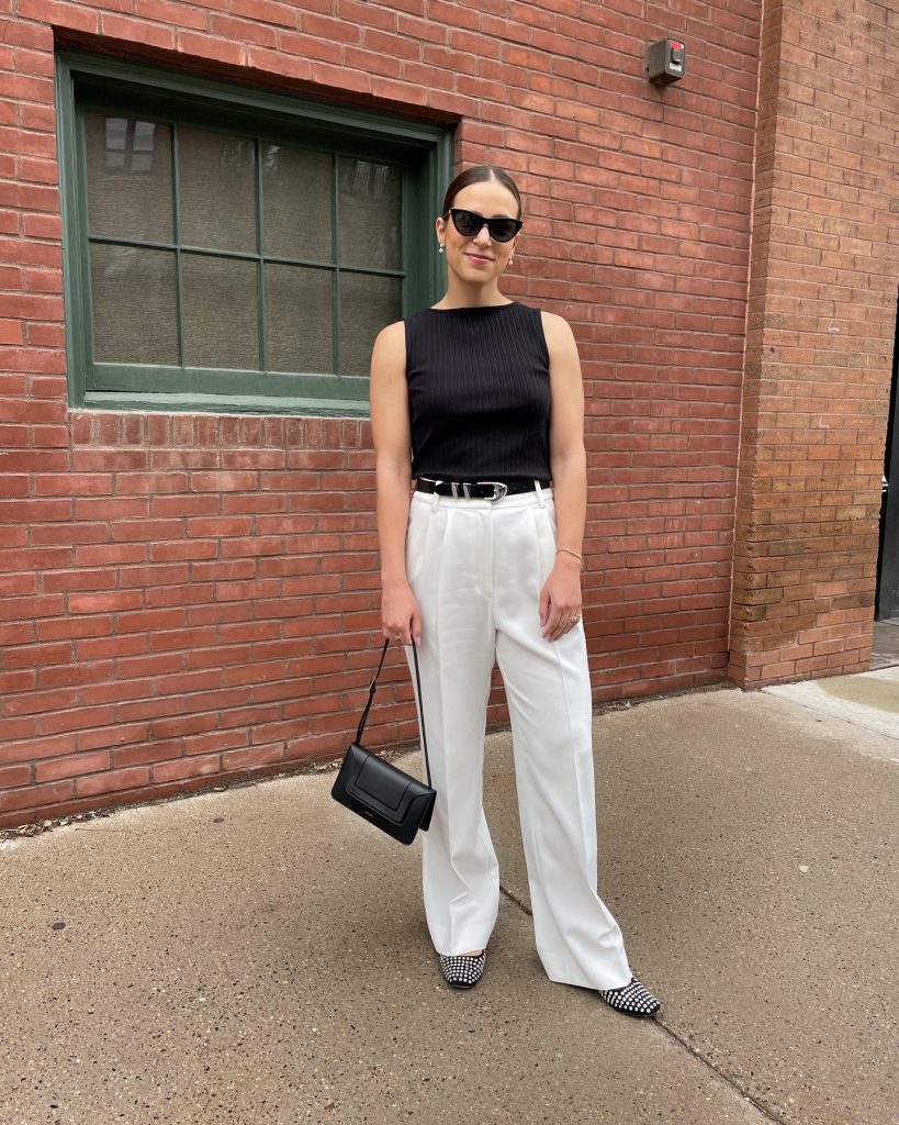 Black Sleeveless Top + White Pleated Trousers + Black Western Belt