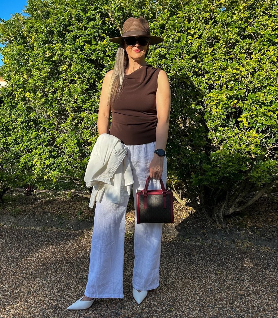 Brown Cowl Neck Top + White Linen Trousers + Straw Fedora