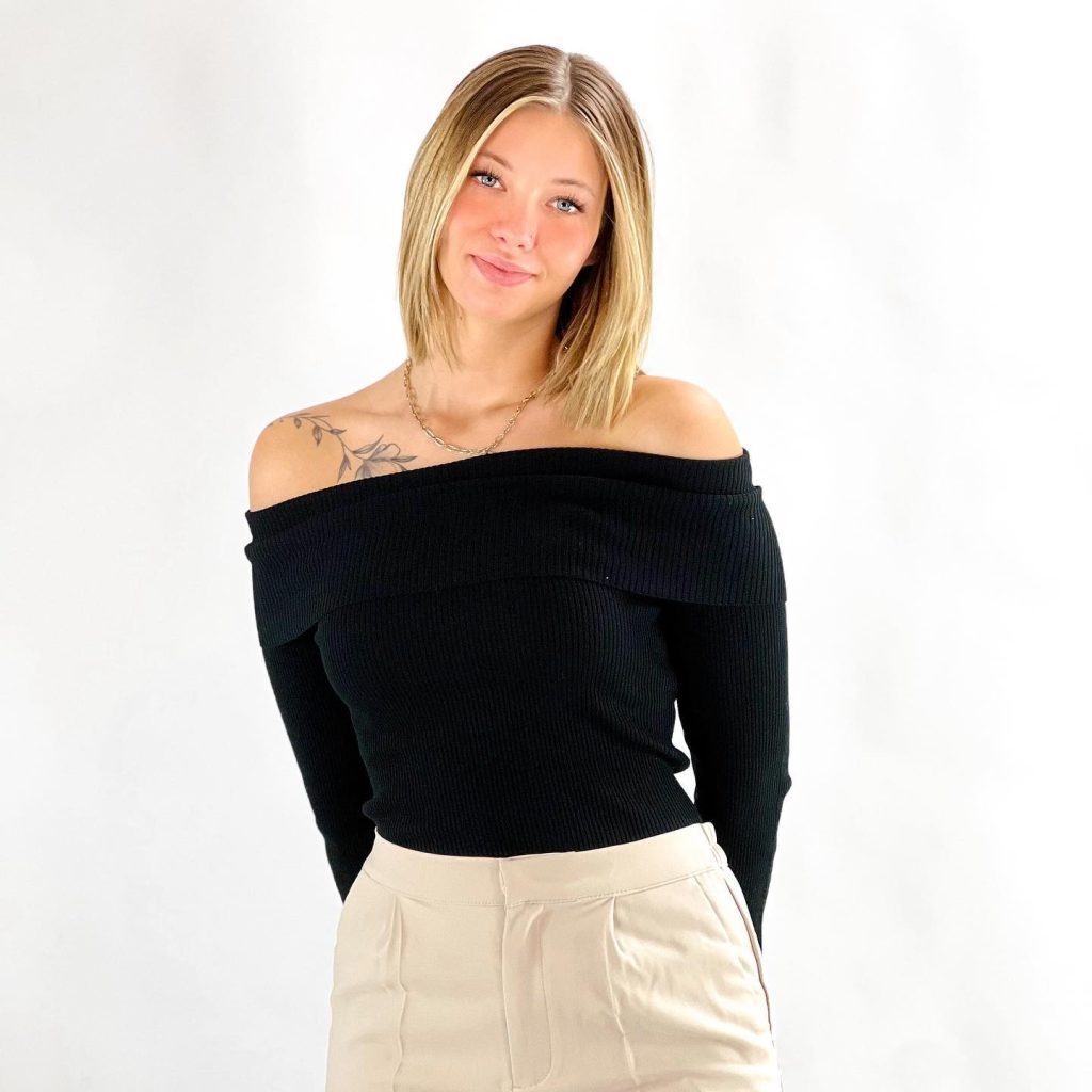 Black Ribbed Off-Shoulder Sweater + Beige Pleated Trousers