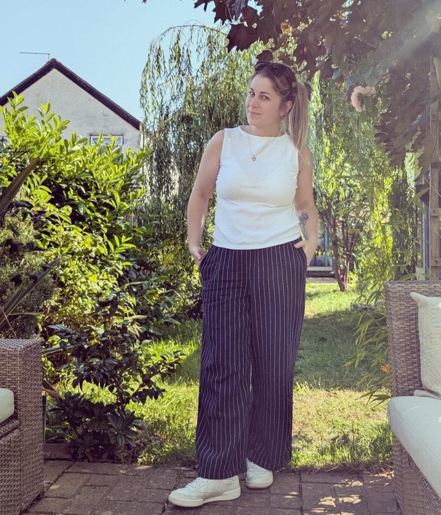 White Sleeveless Top + Pinstripe Wide-Leg Pants + Sneakers
