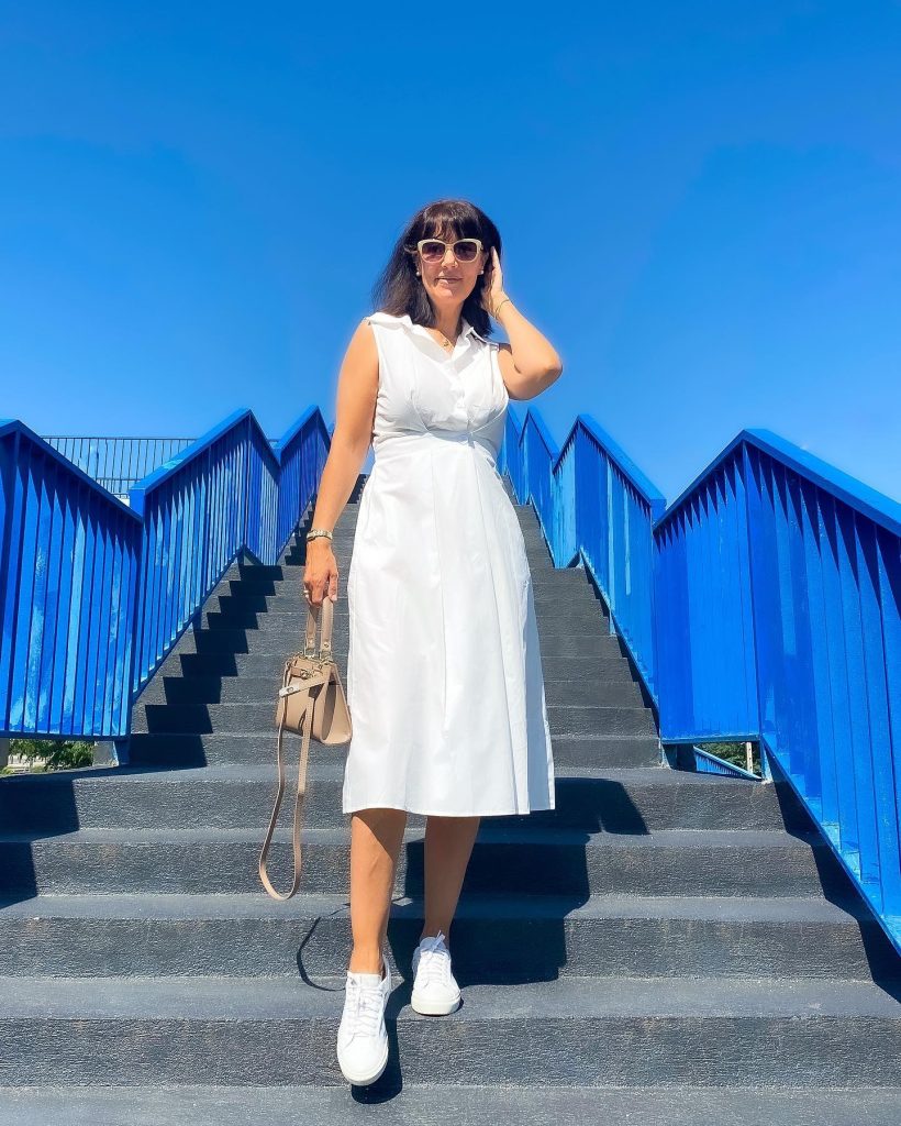 White Sleeveless Shirt Dress + Neutral Handbag + White Sneakers