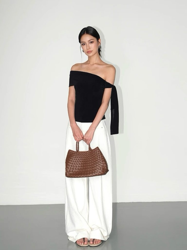 Black One-Shoulder Top + White Wide-Leg Trousers + Brown Woven Bag