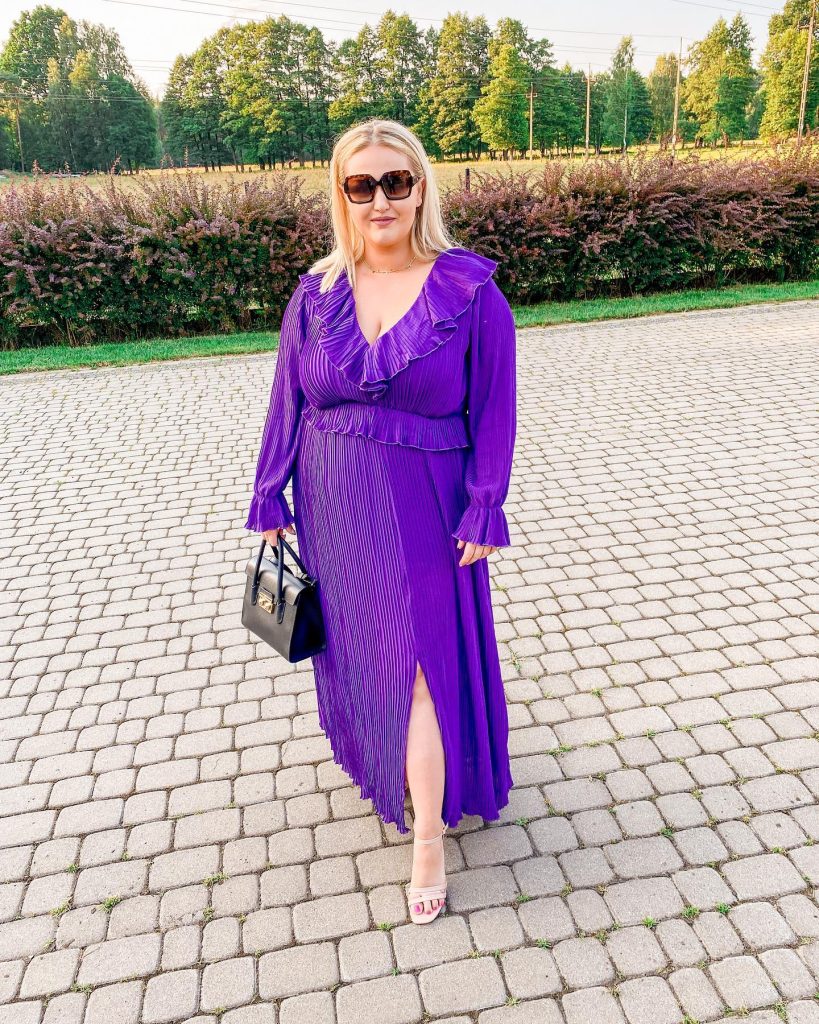 Purple Pleated Dress + Ruffled V-Neck + Black Handbag