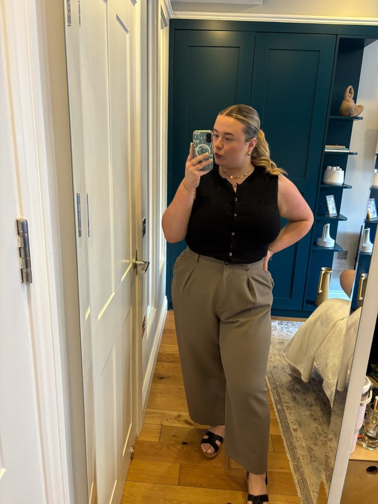 Taupe Pleated Pants + Black Sleeveless Button-Up + Black Sandals
